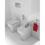 Bathroom with white toilet and red towel on a white wall