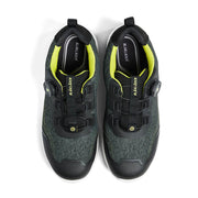 Pair of black and green safety work shoes with yellow accents on a white background