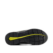 Black shoe sole with yellow accent on a white background