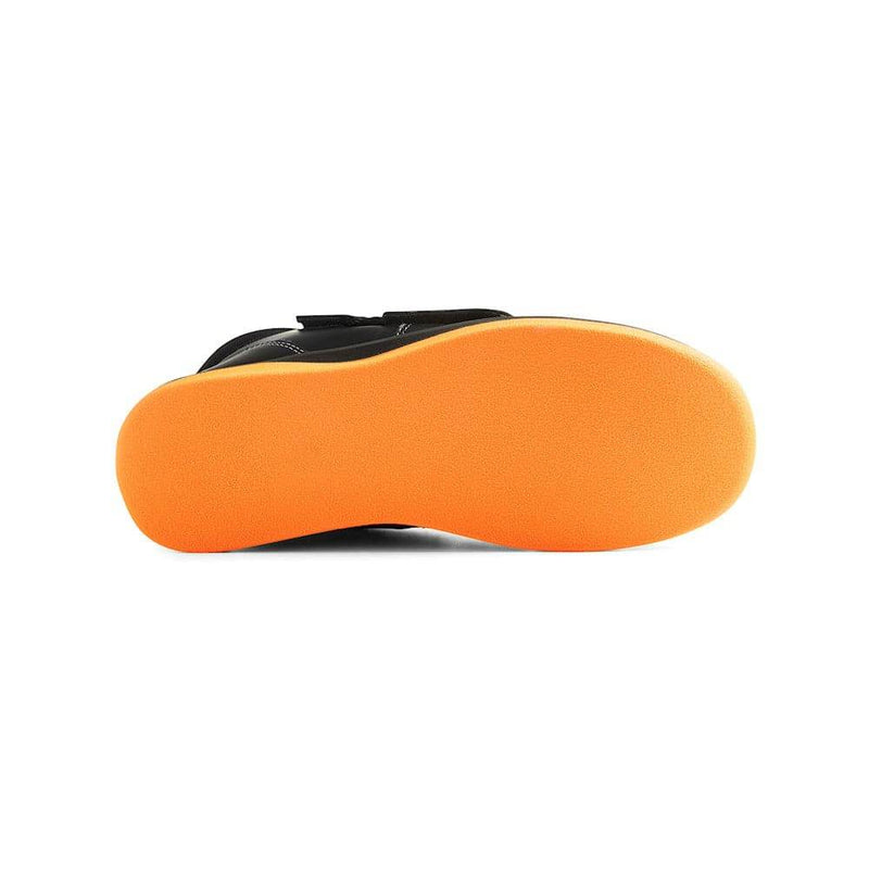 Black shoe with orange sole on a white background
