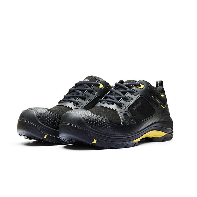 Black safety shoes with yellow accents on a white background
