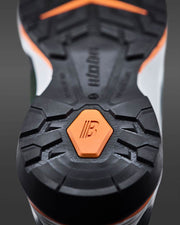 Close-up of a shoe sole with a brand logo on a gray background