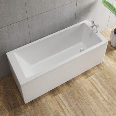 White freestanding bathtub in a bathroom setting with wooden floor and tiled wall.
