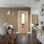Modern interior design with wooden door, dining table, and chairs.