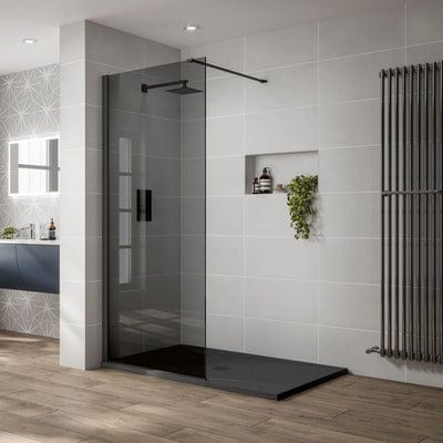Modern bathroom with a shower area featuring a glass door and black tray.