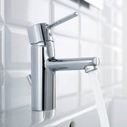Chrome faucet mounted on a tiled wall