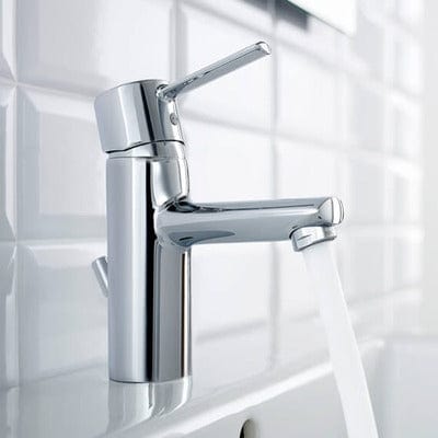 Chrome faucet mounted on a tiled wall