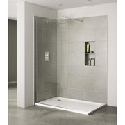 Modern shower enclosure with glass door in a tiled bathroom