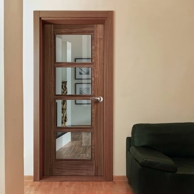 Wooden door with glass panels in a room with a green sofa.